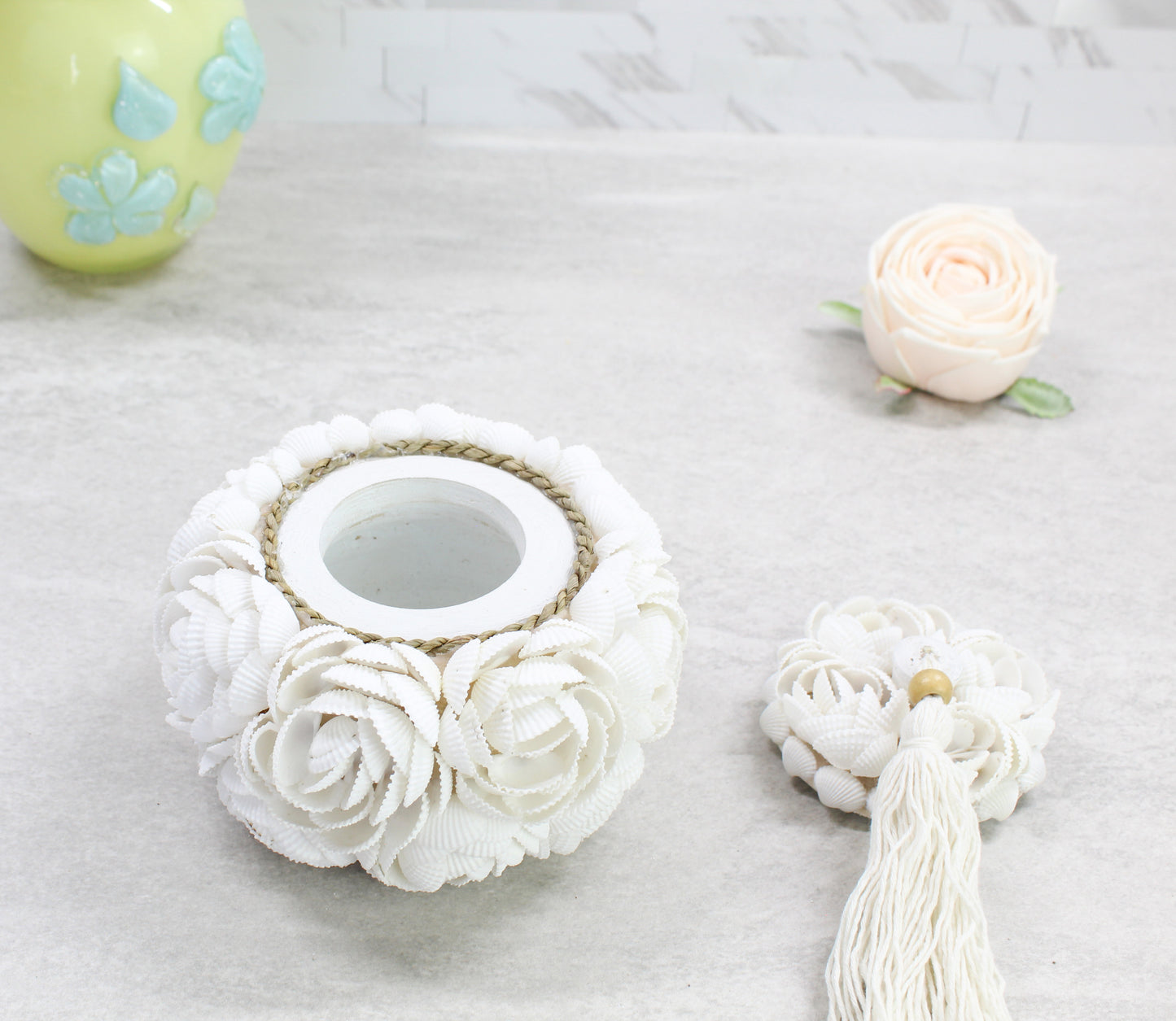 Open seashell rose jewelry storage box showing interior compartment and removable tassel lid, handcrafted from white seashells for coastal elegance.