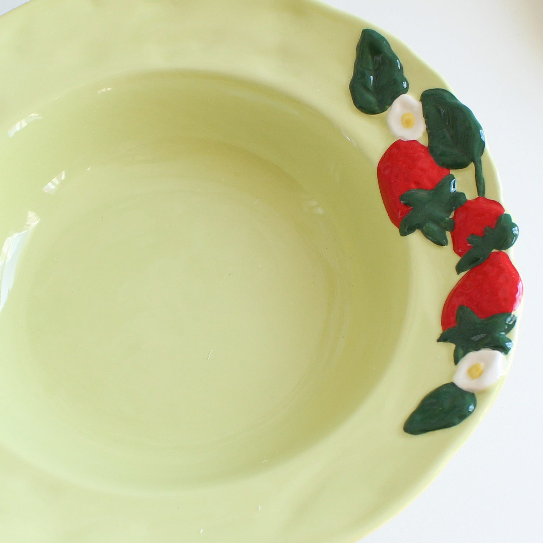 Close-up of strawberry embossed stoneware pasta bowl, 9 inch glazed ceramic kitchenware