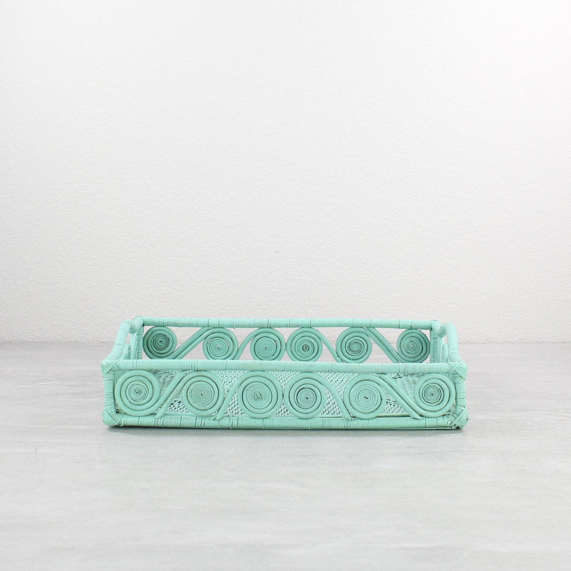 Small swirly rectangle rattan tray in sage leaf green, tight-woven with handles, shown on white background for product display