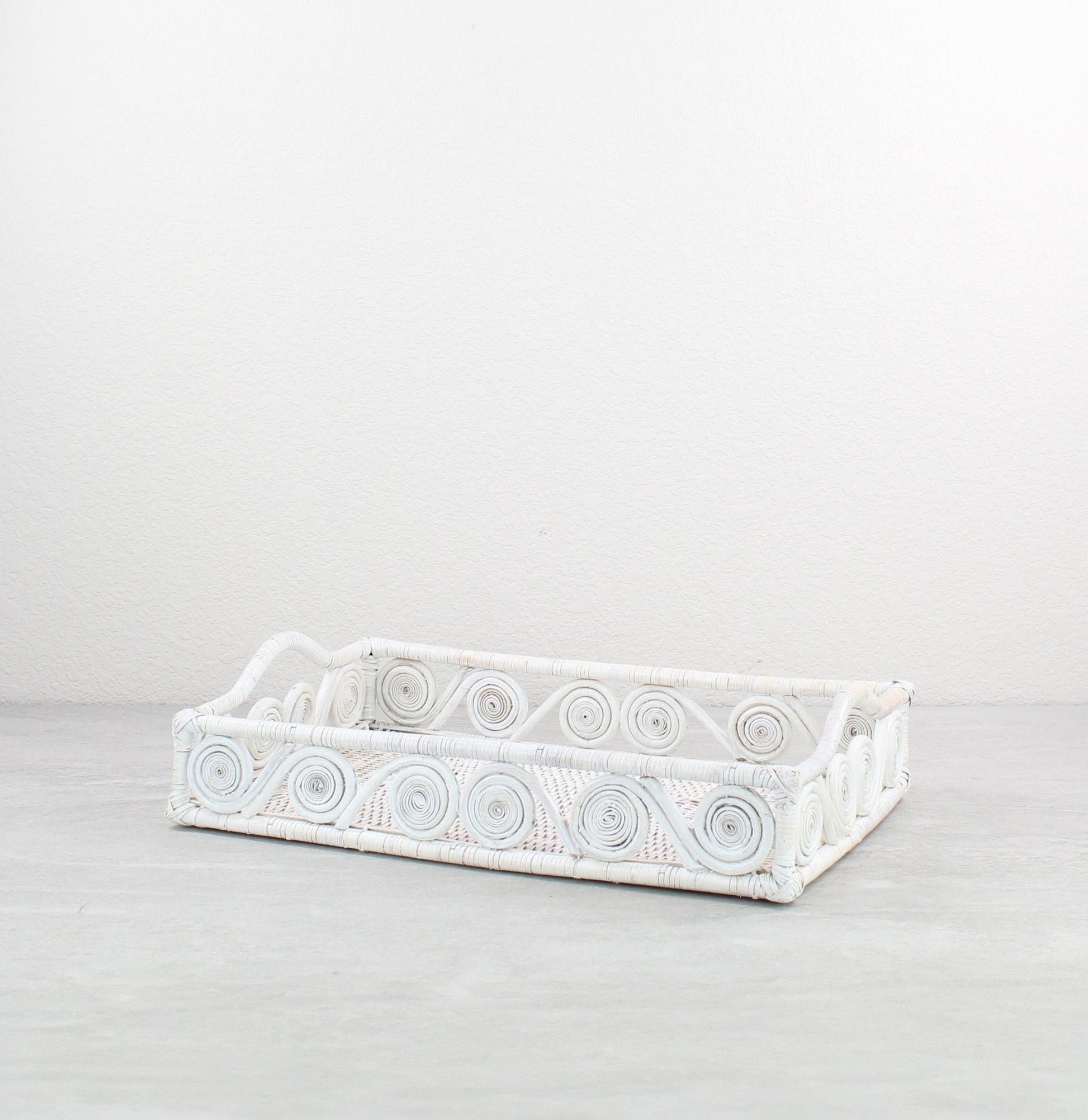 Small swirly rectangle rattan tray in whitewash, tight-woven with handles, shown on white background for product display