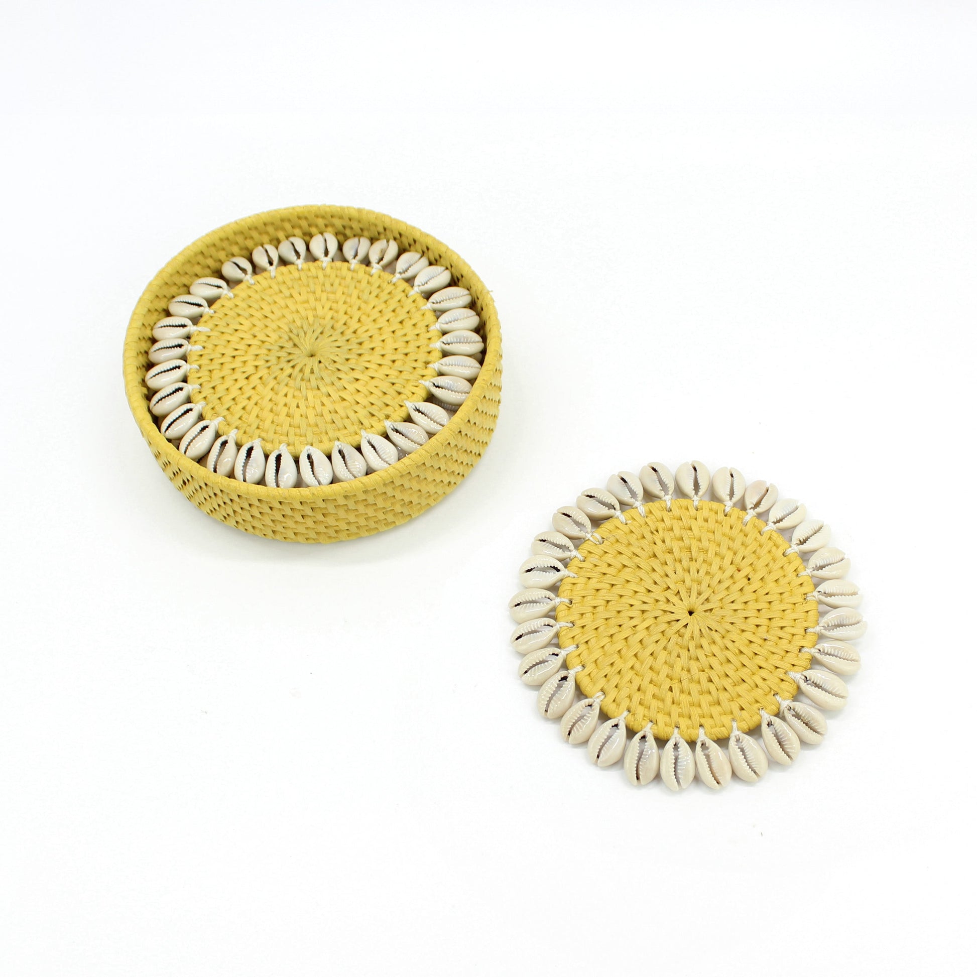 Set of yellow rattan coasters with natural seashell trim and matching holder, artisan handmade eco-friendly tableware