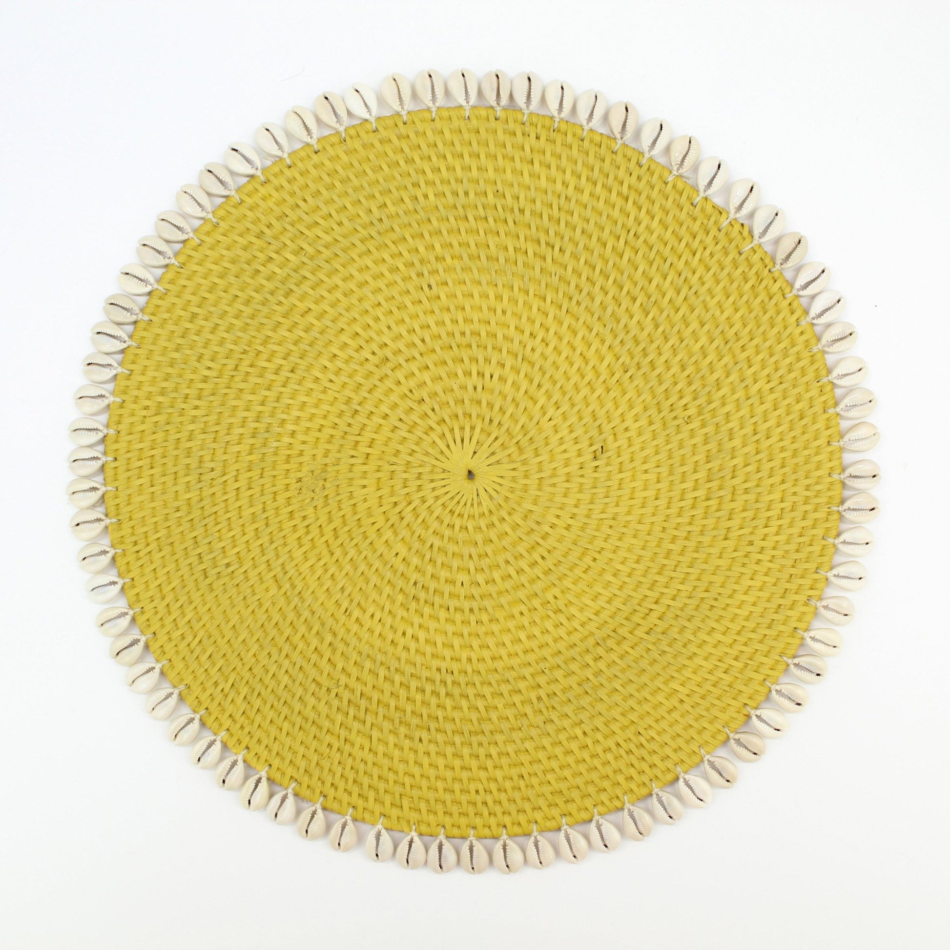 Handmade yellow rattan placemat with natural seashell trim, shown on white background for clean, product-only display