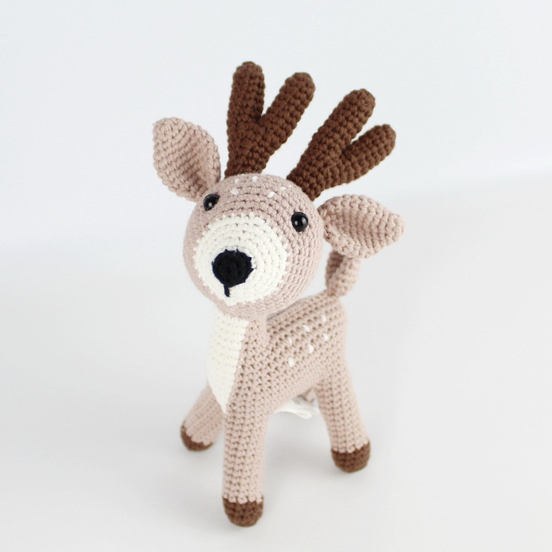Handmade khaki crochet deer amigurumi with brown antlers, eco-conscious and artisanal, designed for holiday gifts or nursery décor.