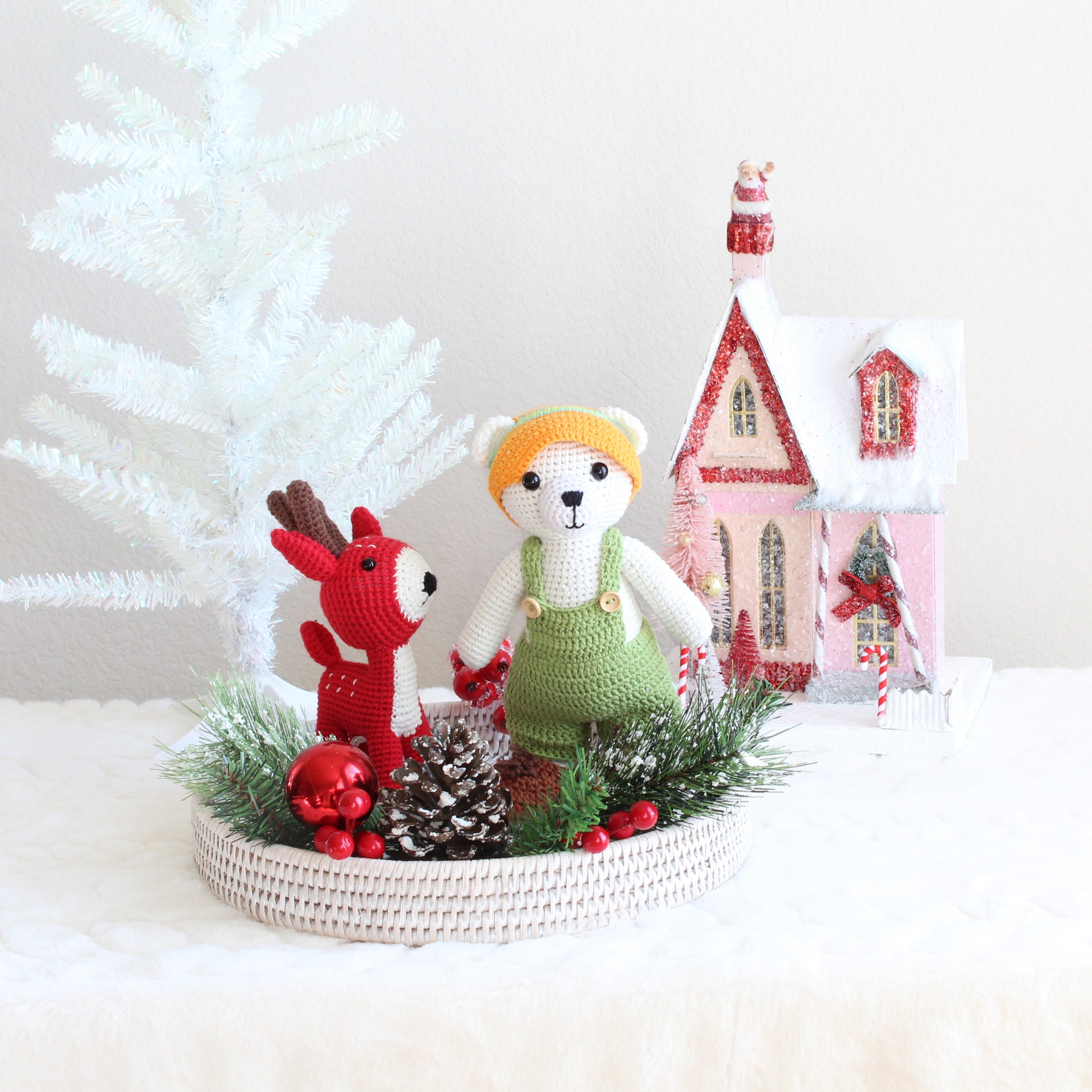 Eco Handcraft holiday gift set with handmade polar bear and red deer amigurumi displayed on a whitewash rattan tray with festive Christmas décor.