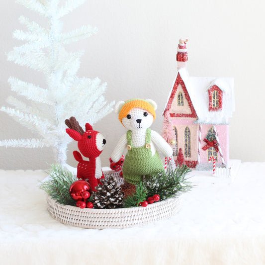 Eco Handcraft holiday gift set with handmade polar bear and red deer amigurumi displayed on a whitewash rattan tray with festive Christmas décor.
