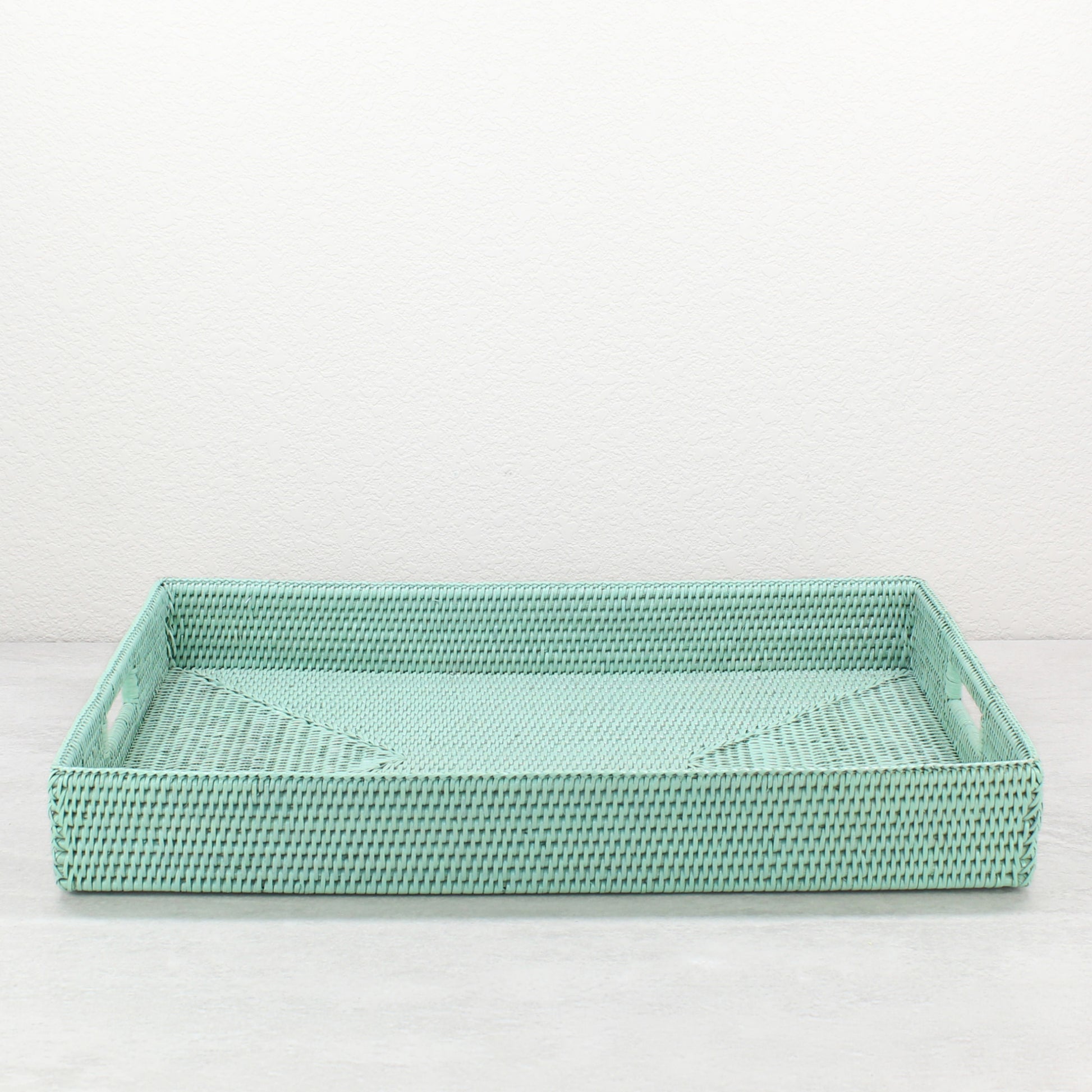 Handwoven sage leaf rattan storage tray with handles, shown in extra-large size for versatile dining, entertaining, or organizing