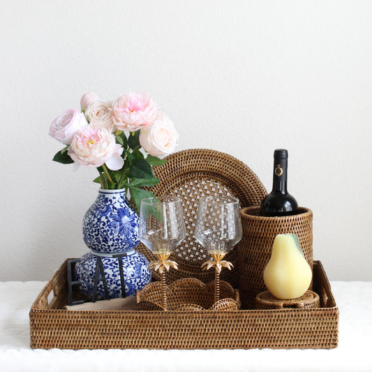 Eco Handcraft honey brown rattan wedding gift set with tray, coasters, wine holder, and decor styled with flowers and wine