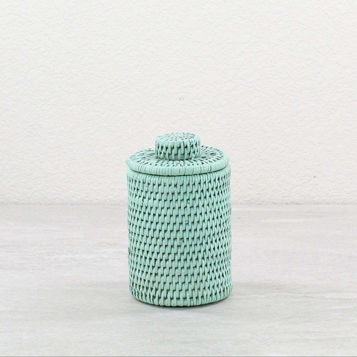 Handwoven sage leaf green rattan round basket with lid, eco-friendly decorative canister for bathroom or vanity storage