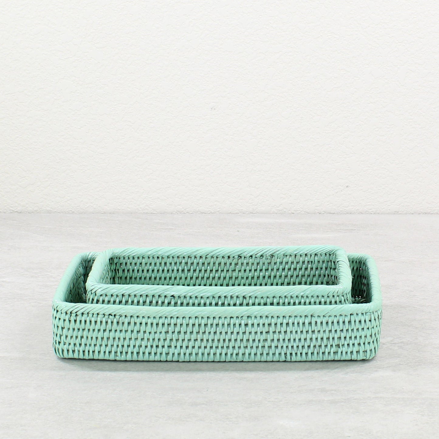 Small and medium sage leaf green rattan bathroom organizing trays, handwoven eco-friendly storage solution