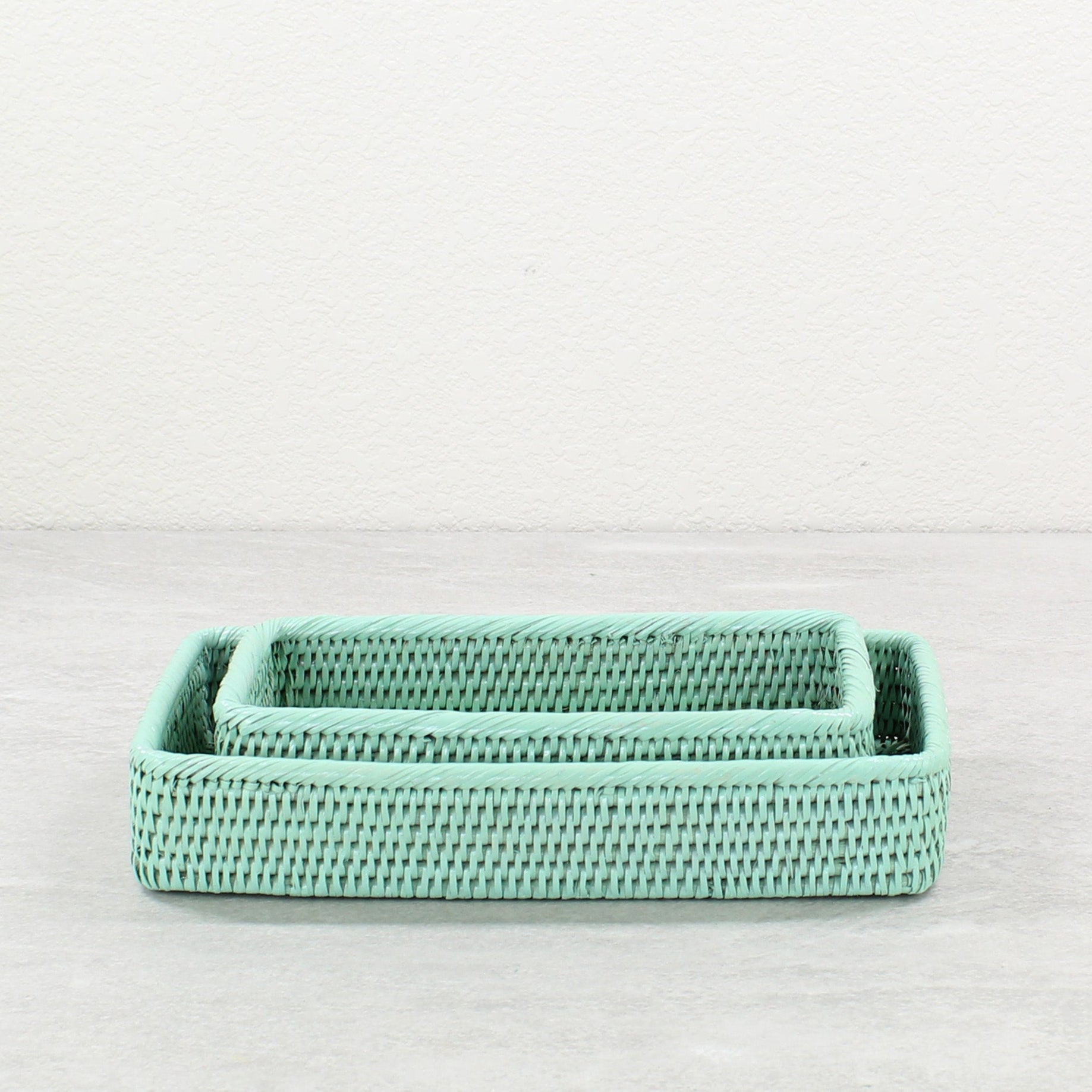 Small and medium sage leaf green rattan bathroom organizing trays, handwoven eco-friendly storage solution
