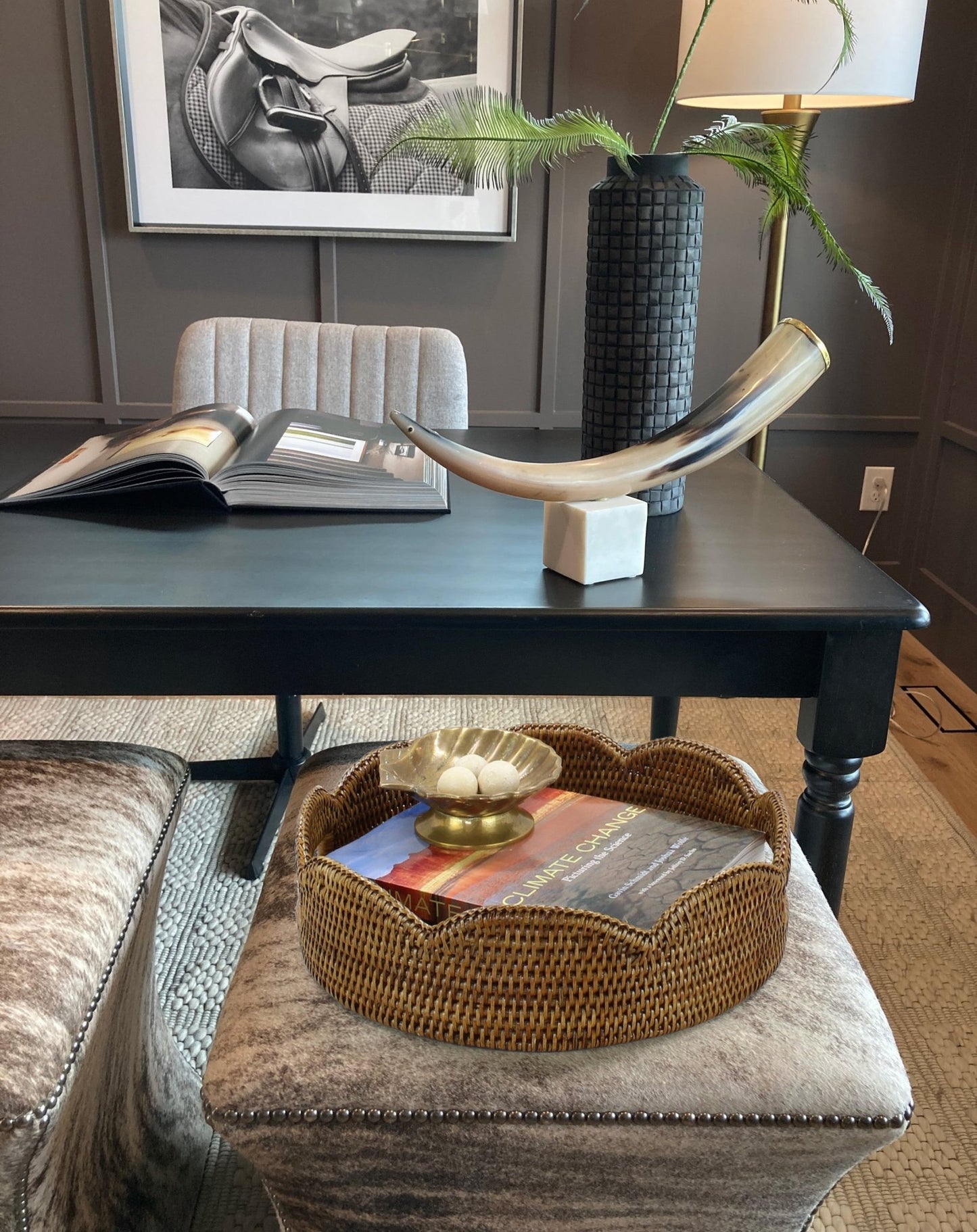 Honey brown scalloped rattan tray styled on ottoman in office with decorative bowl and book for modern accent decor.