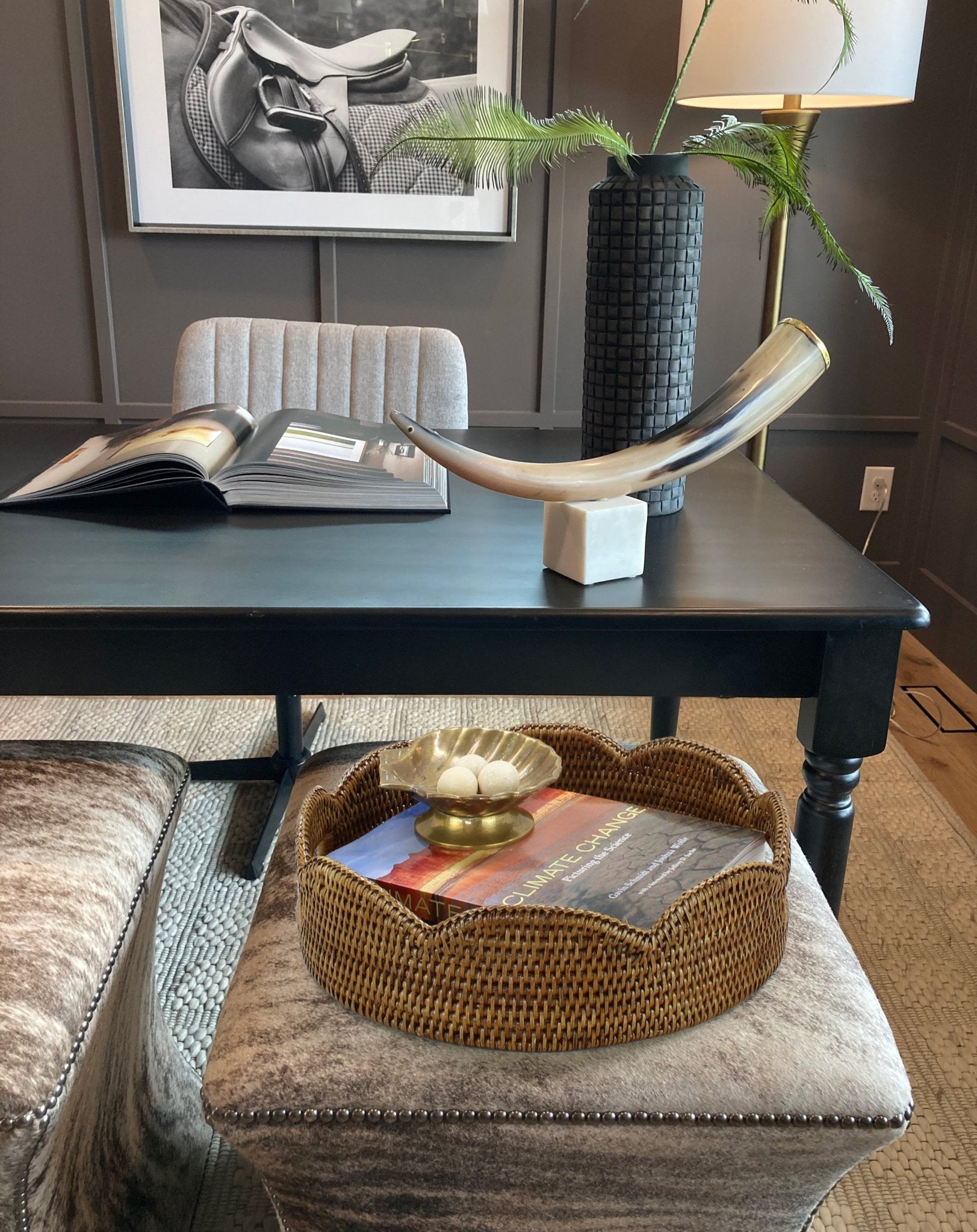 Honey brown scalloped rattan tray styled on ottoman in office with decorative bowl and book for modern accent decor.