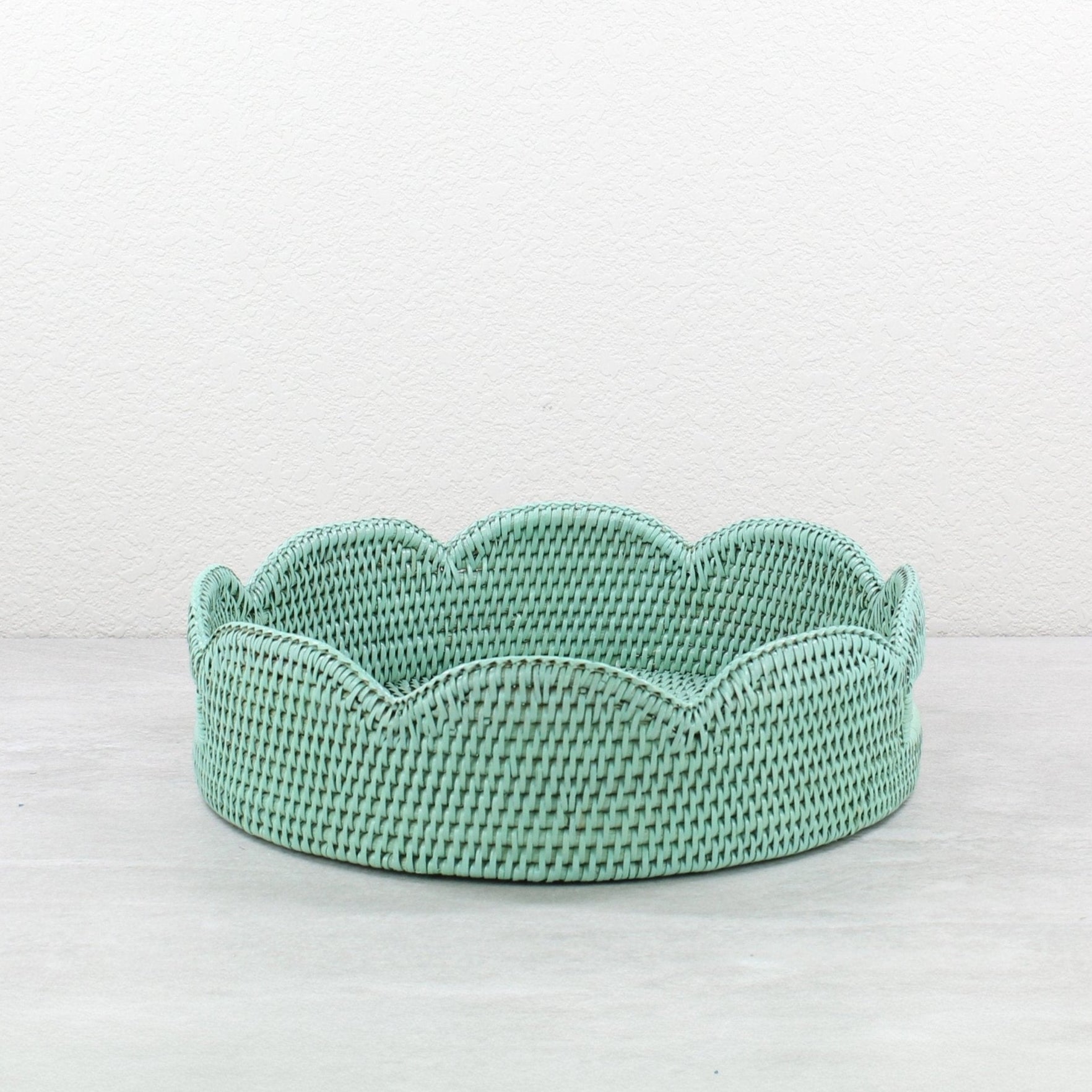 Sage leaf green scalloped round rattan tray handmade from Burmese rattan, shown empty against a neutral background.