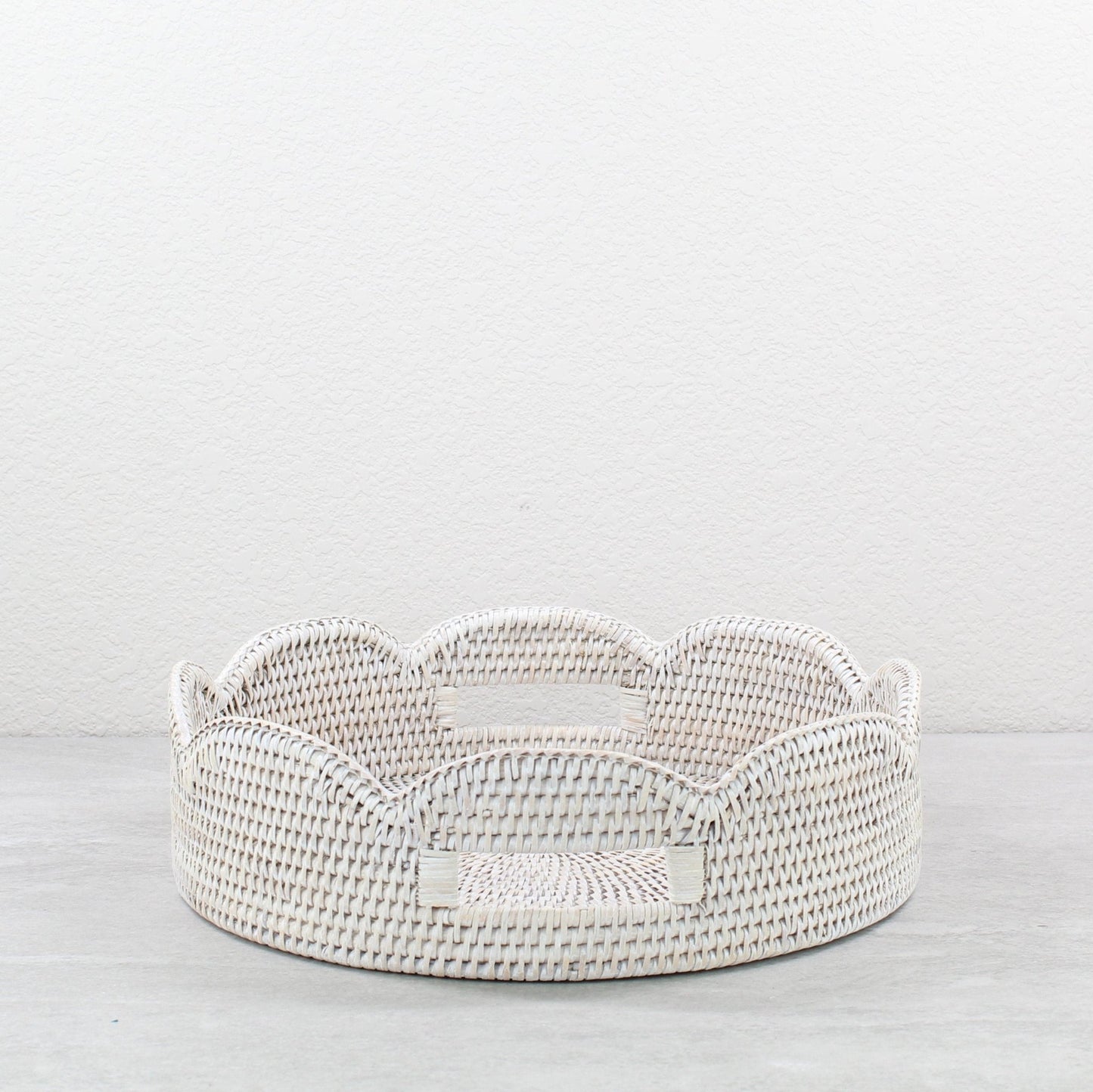 Whitewash scalloped round rattan tray handmade from Burmese rattan, shown empty as versatile decorative storage.