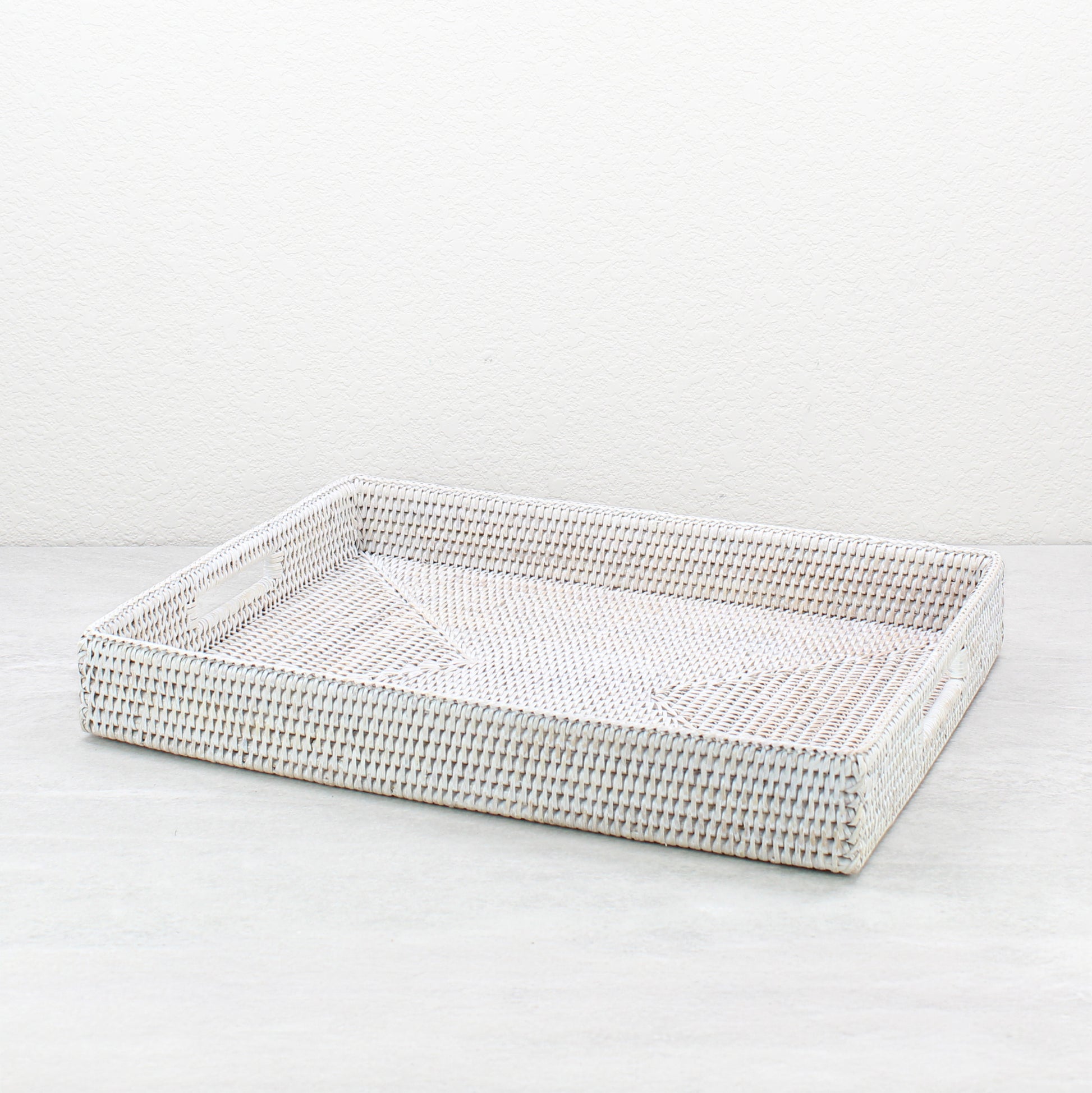 Handwoven whitewash rattan rectangular storage tray with handles, large size, eco-friendly organizer for coffee tables and countertops.